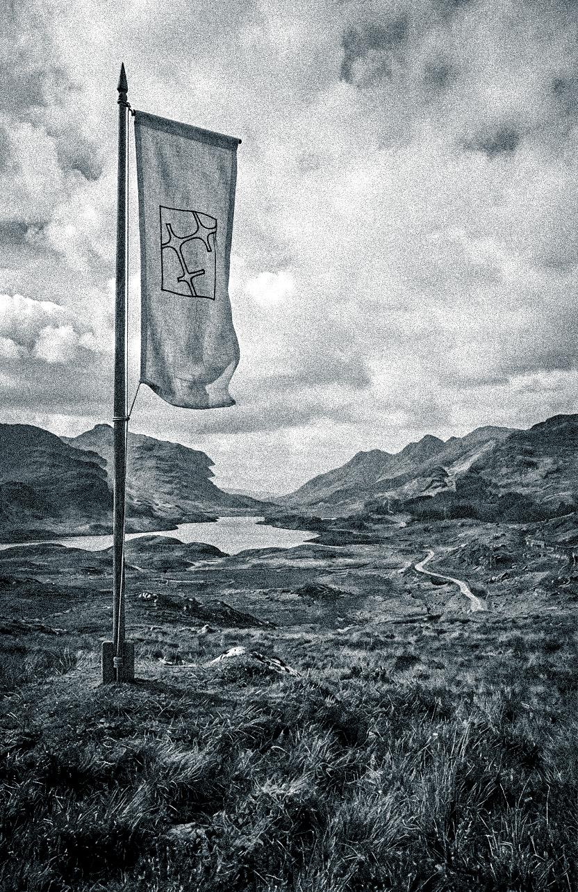 Fracture Collectif flag over a mountainous landscape